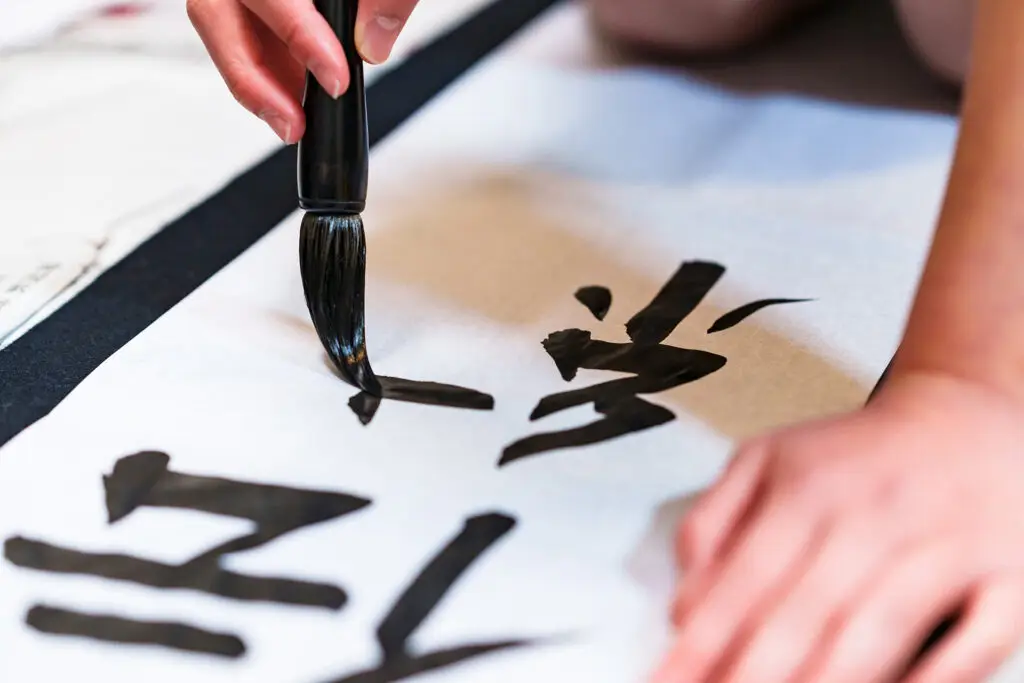 Person painting calligraphy