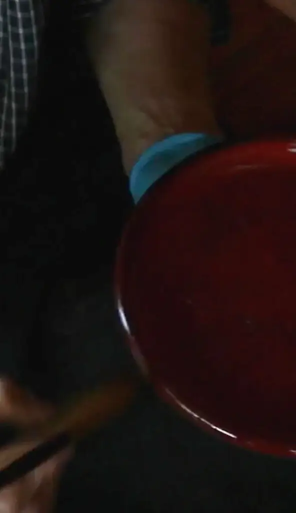 A red apple sitting on top of a table.